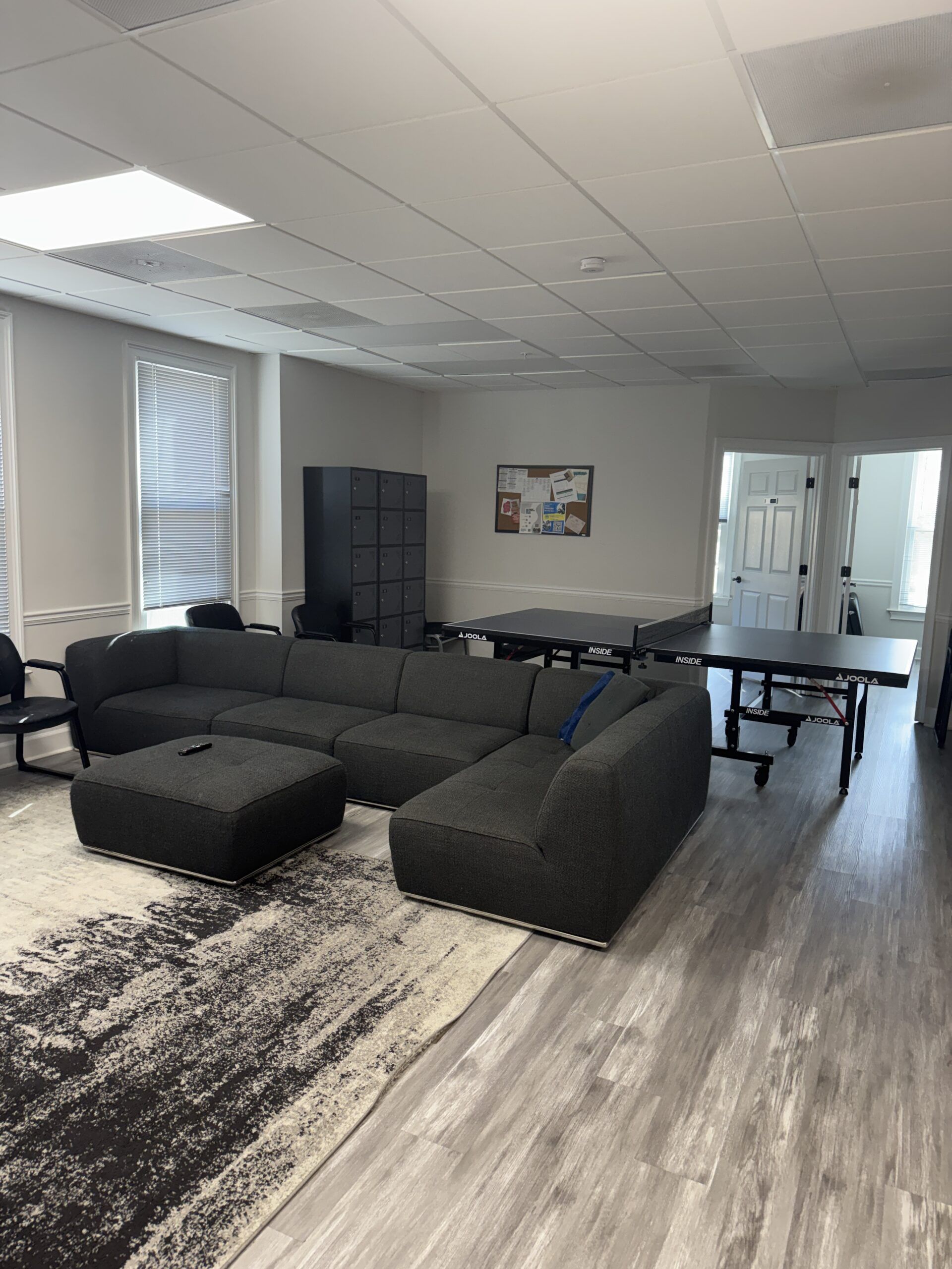 Our rec room with a sofa and ping pong table at Empowered Recovery Center in Atlanta