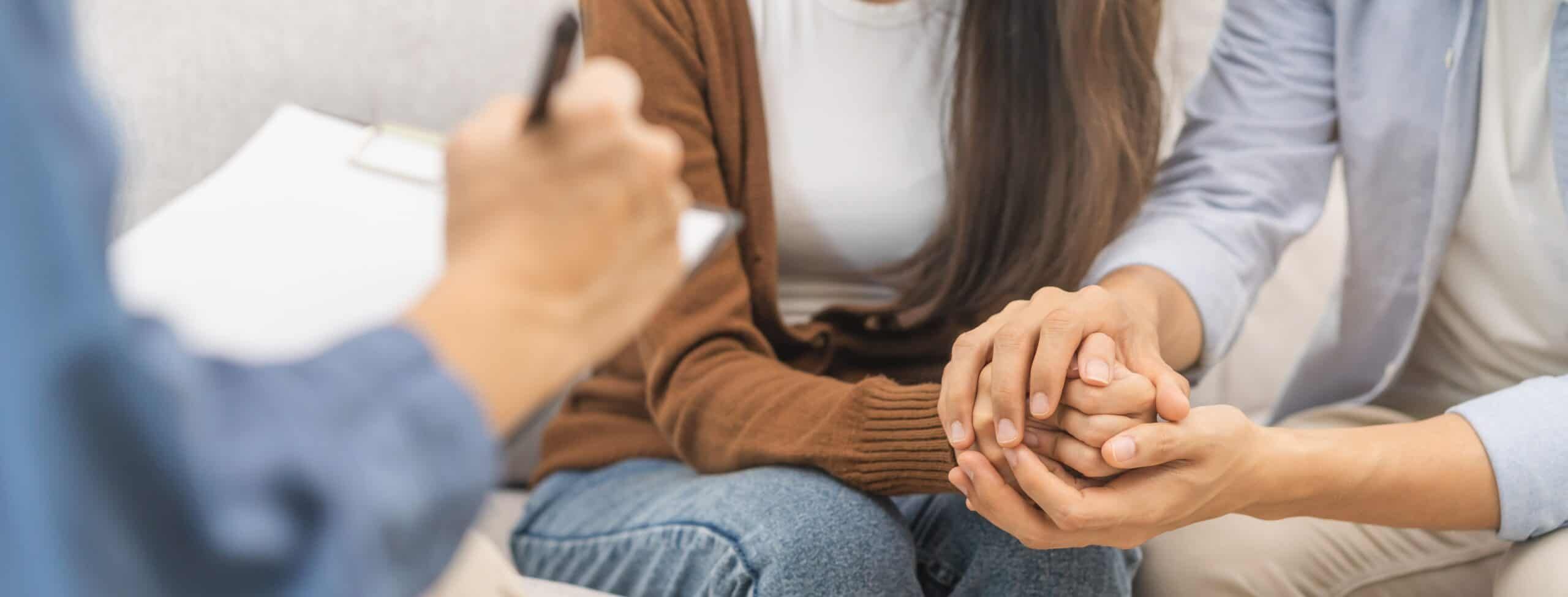 couple holding hands during family therapy in Atlanta, GA