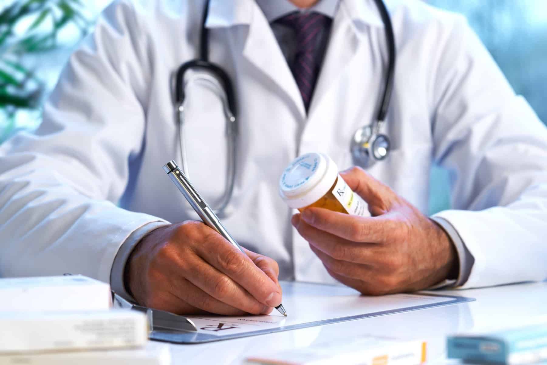 doctor filling out script for medication assisted treatment in Alpharetta